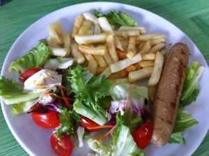 Sausage plate with salad and french fries at Gandhi Veggie in Barcelona