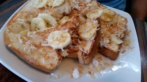 Vegan French Toast with bananas, toasted coconut, and coconut syrup. Amazing! Best I've ever had! at Mesa Cafe in San Pedro