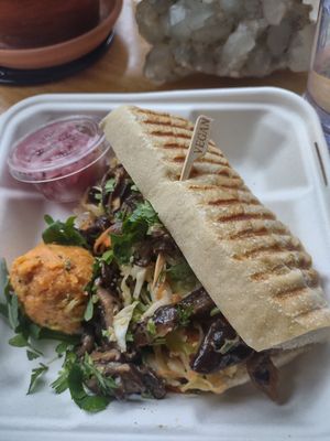 Mushroom banhi mi, w/ potato sald, add pickled oinions. Delicious! I also got a Medicine Mylk, not pictured here, & water.. It was great, but expensive. at Pulp + Sprout Juice Bar and Vegan Cafe in Asheville