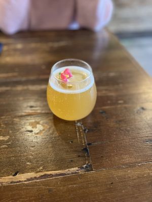 Pineapple turmeric kombucha on tap, garnished with a cute little flower!  at VegeNation in Las Vegas