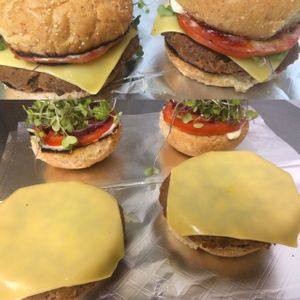vegan seitan cheeseburger with local sprouts (cuttings no roots) tomato and onion.  at Planet Yum in Vero Beach