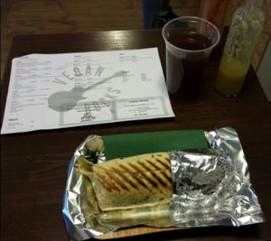 Generously-sized Pastor Burrito - tasty beyond words - accompanied by a refreshing dark lemonade. at Momencik in Warsaw