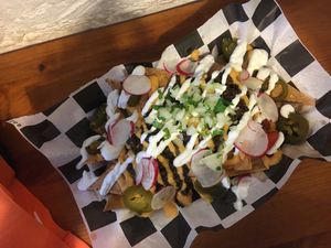 Nachos!!! There’s chilli beans and corn chips under there!  at Momencik in Warsaw