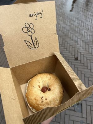 cinnamon raisin bagel with strawberry jam and cream cheesee  at Bagels & Beans - Spui in The Hague