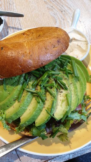 bagel with avocado, salad and vegan cream cheese on the side at Bagels & Beans - Spui in The Hague