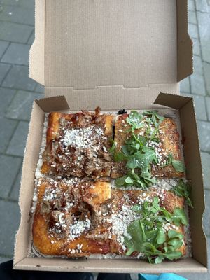 Vegan pulled pork (left) & vegan arrabbiata - with extra vegan Parmesan on top   at Sugo Pizza Al Taglio - Aert van Nesstraat in Rotterdam