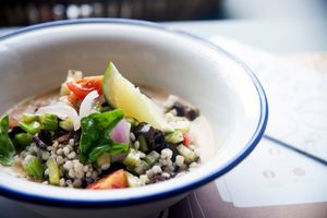 Bio sorghum tabulé with celery, cucumbers, red onion, tomatoes, basil, olives, origan and raspberries and yellow peaches cold soup at Frulez in Bari