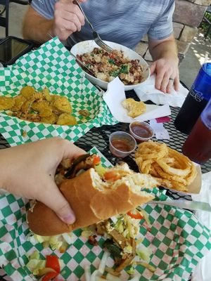 Fried Pickles appetizer, Cheesesteak with onion rings, and Bean Bowl with a biscuit at Bean Vegan Cuisine in Asheville