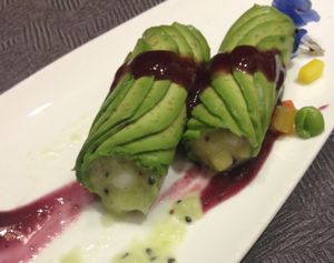 Avocado-wrapped dragon fruit with blueberry sauce. at Huā Kāi SùShí 花开素食 - Dongcheng in Beijing