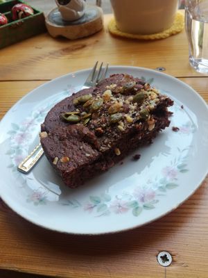 Chocolate brownie with hazelnut sprinkled on top with pumpkin seeds at Lokaal in Ghent