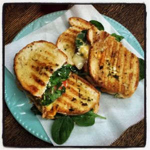 The Old Goat - Cheddar and Goat Cheese Panini with Spinach, Arugula, and Tomato grilled with Herb butter  at Southern Juice and Beverage Co. in Gallatin