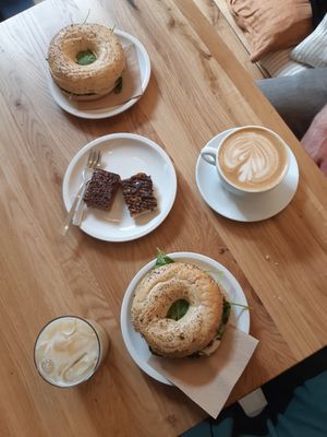 Ice chai latte, almond crunch chocolate thing, peanut crunch chocolate thing, bagels & oat milk cappuccino at Cafe Neundrei in Berlin