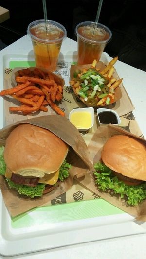 2x menu. Big veganski and Veganizer with sweet potato fries, chili-peanut-onion fries, garlic mayo and smokey bastard bbq sauce and two homemade ice teas at VINCENT - Europa Passage in Hamburg