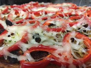 Vegan pizza with flat veg sausage and mozzarella  at Loving Hut in Sofia