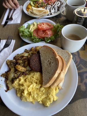 UNusual breakfast with potatoes, sourdough and veggie sausage + avocado and tomatoes; vanilla oat latte  at Crossroads Cafe in Joshua Tree