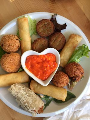 Selection of fried snacks, like cashewballs and springrolls. at Loving Hut in Amsterdam