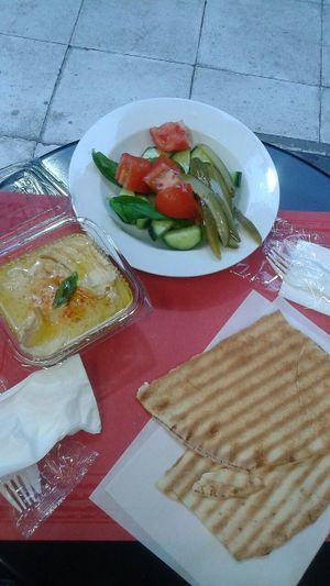 Hummus with salad and pita bread at Enjoy Just Falafel  in Athens