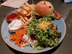 Burger with fries and salad at Cafe Rost in Mannheim