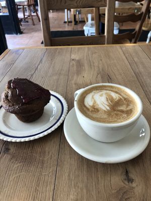 Oat milk latte with some kind of jam muffin   at Cafe Tuyo in Montreal