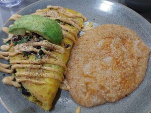 Just Egg and black bean omelette topped with avocado and microgreens with grits. at Hot Stacks Cafe in Myrtle Beach