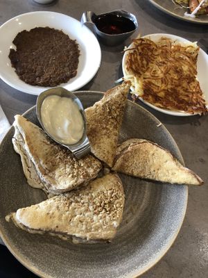 Vegan French Toast with added sausage patty and hashies! Soy yogurt and blueberries come with the toast! at Hot Stacks Cafe in Myrtle Beach