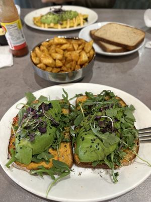 Avocado Toast comes with fresh fruit (came out before main dish and already ate it before pic.  Sliced banana, blueberries, strawberries.). Also got a side of home fries. #Veganuar at Hot Stacks Cafe in Myrtle Beach