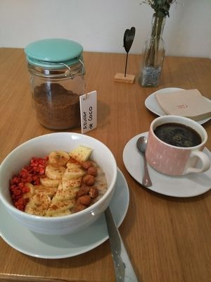 chia bowl with fruits and coffee at Dellicare Cafe in Madrid