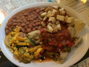 Vegan tamales, with red and green chile. Served with beans, grilled potatoes, and calabacitas. at Tia Betty Blue's in Albuquerque