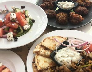 Greek salad with vegan feta, fritters with vegan tziaki and gyros platter! at Mama Tierra in Athens