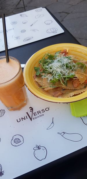 Tropical juice (so good) and cauliflower ravioli in creamy sauce at Universo Vegano in Florence
