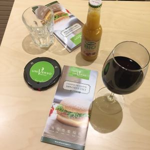 Service at counter aided by individual electronic call disk for diners. at Universo Vegano in Florence