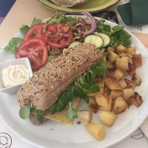 Crispy truffle $15 - bread, quinoa courgette and tofu burger, truffle sauce, nuts, valerian salad, vegan cheese with mushrooms  at Universo Vegano in Florence