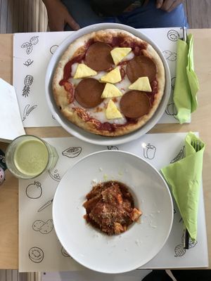 Hawaiian pizza and ravioles  at Universo Vegano in Florence