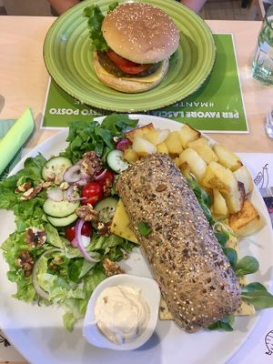 Classic burger & super truffle burger with potatoes and salad  at Universo Vegano in Florence