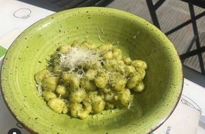 Vegan gnocchi with pesto and vegan cheese at Universo Vegano in Florence