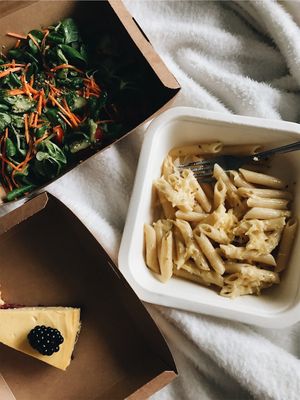 Pasta with vegan cheese, veggie salad with homemade pesto and hemp seeds, raw mango cake with blackberries. 💚 I had my takeaway and it was d-e-l-i-c-i-o-u-s!!  at Bhajan Cafe in Riga