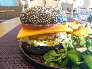 This burger at Bhajan was impressive: my first charcoal burger, a savoury patty and a great side salad. at Bhajan Cafe in Riga