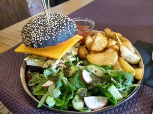 The side salad here was as tasty as the burger: fresh and light, ideal to go with the nice chunky potatoes and the savoury burger. at Bhajan Cafe in Riga