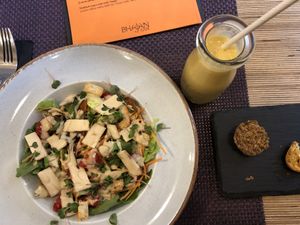 Caesar salad and mango lassi  at Bhajan Cafe in Riga