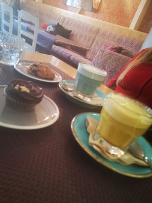 Safire and golden latte with som sweets at Bhajan Cafe in Riga