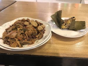 Rice with jackfruit curry and two different vegan sausages, and sticky rice with beans in banana leaf. All together: 100 baht.  at Im Jai - Veg Food Stall in Chiang Mai