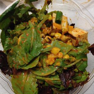 Baby greens, grilled organic Piri Piri Tofu, roasted corn, mangoes, avocado, MAD spice, green onion, & Red Pepper dressing at MAD Greens in Tempe