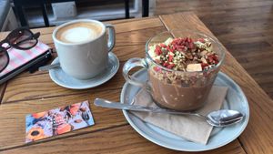 Cappuccino homemade almond milk and goji granola with apple and cacao topping  at Naspolya Nassolda in Budapest