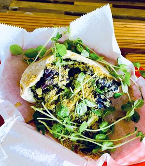 Sem Sandwich: pita, hummus, mixed greens, mixed veggies, cilantro-cashew pesto, cashew crème, goji dressing  at Judahlicious in San Francisco
