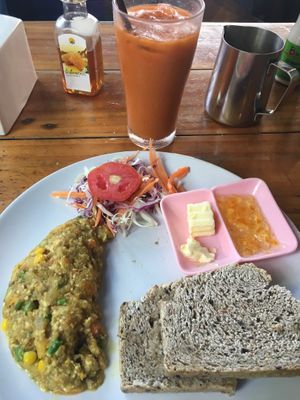 Vegan omelette, whole-wheat bread, jam & Thai(coconutmilk) iced tea for 100 baht. So so good! at Peppermaint Guesthouse in Chiang Mai