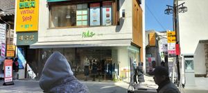 It is down this alley to the right of the vintage shop, see the pink sign in the right? Insadong 6 gil is just out it sight to the right.  Visit the hanok village while in the area at SanChon Korean Temple Cooking - 산촌 사찰음식전문점 in Seoul