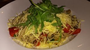 vegan spaghetti dish with olive oil, vegetables and grated non cheese at Pizzeria Manna in Prague