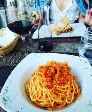 Spaghetti alla bolognese, opposite is the fajita dish at Coox in Turin