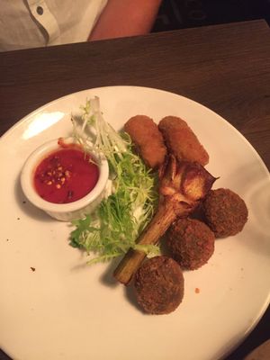 App of eggplant meatballs, fried artichoke, rice balls  at Civico 1845 in San Diego