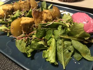Tempeh and spuds on salad with beetroot sauce  at Fram Cafe in Bologna